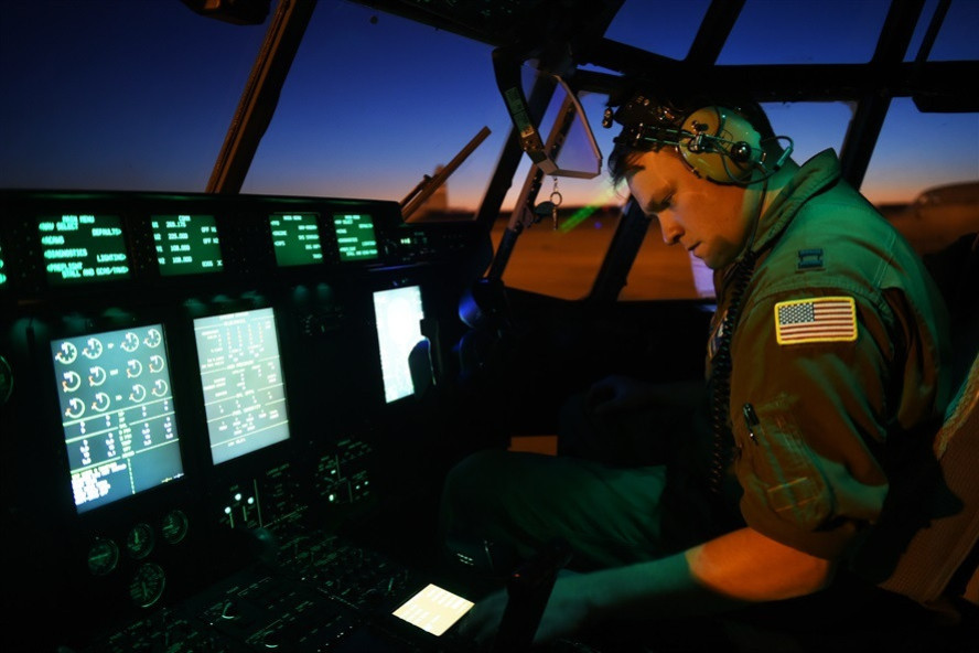 Pilot working at airplane console